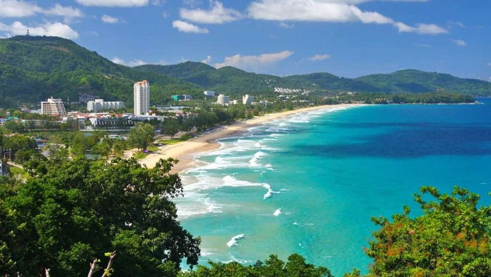 Aerial view of Karon Beach with clear blue water and resorts
