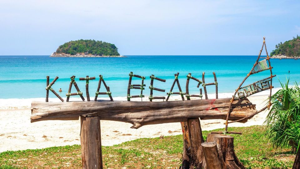 View of Kata Beach with calm waters and palm trees