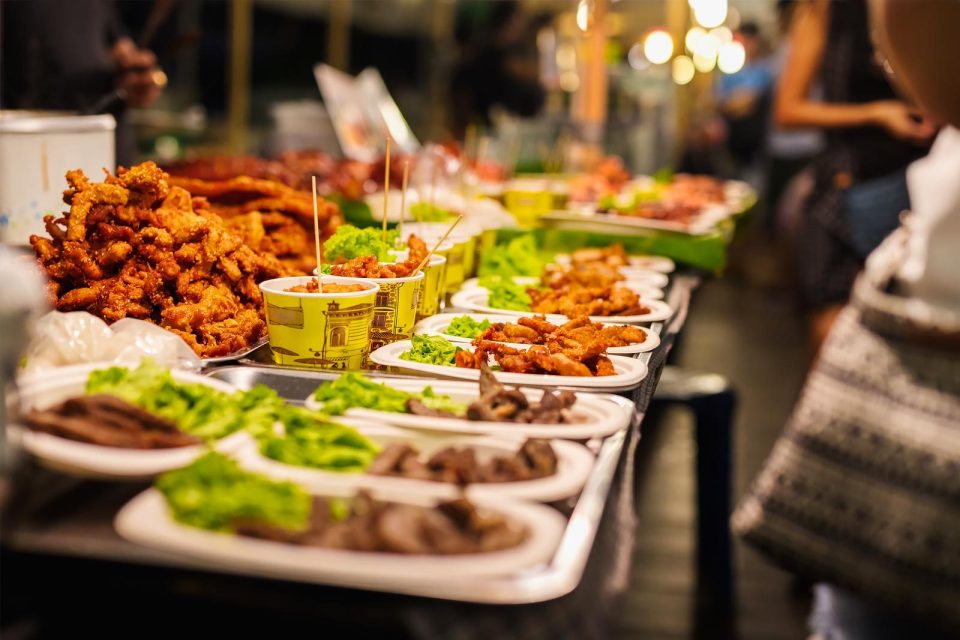 Street food vendor preparing dishes at a night market