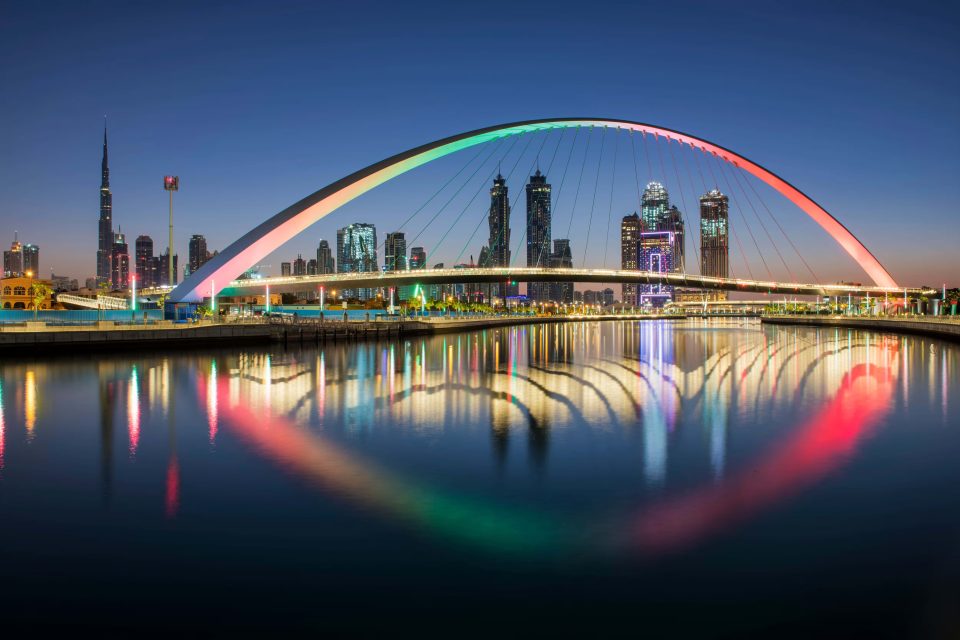 Modern cityscape with the Dubai Water Canal at sunset