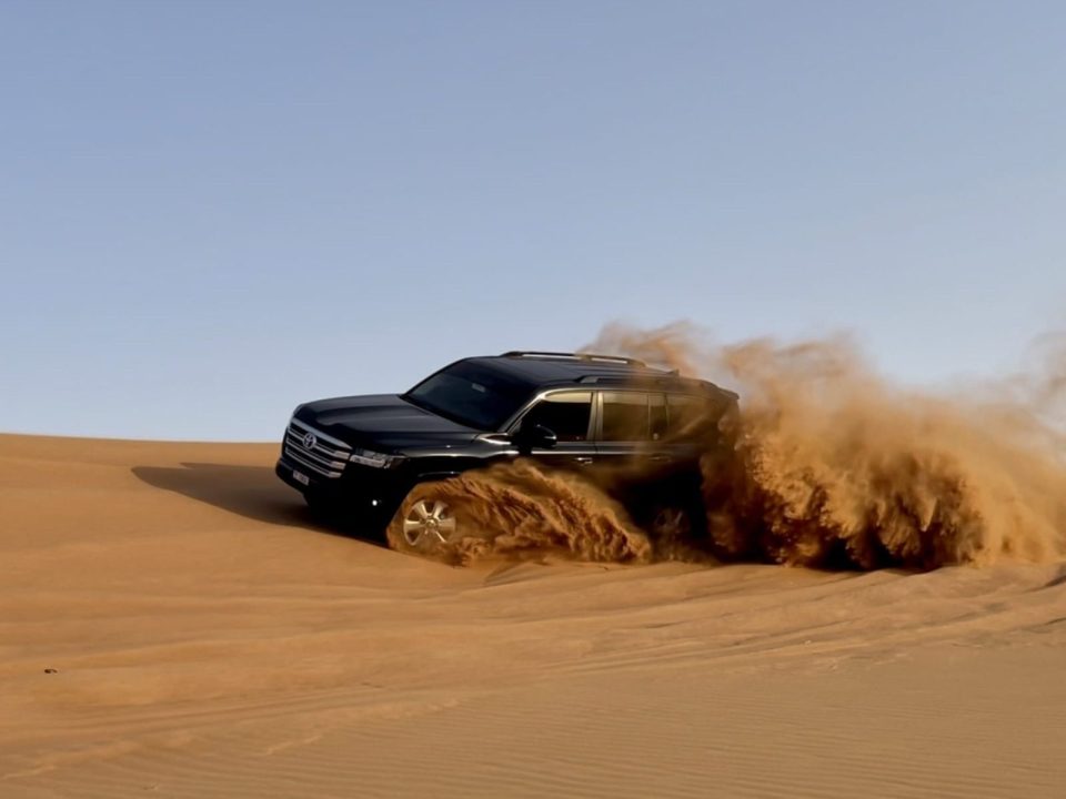 A 4x4 vehicle driving through a rocky mountain landscape during a safari in Fujairah