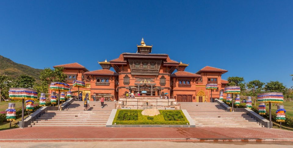 A panoramic view of the Nanshan Buddhism Culture Park with lush greenery and traditional Chinese architecture.