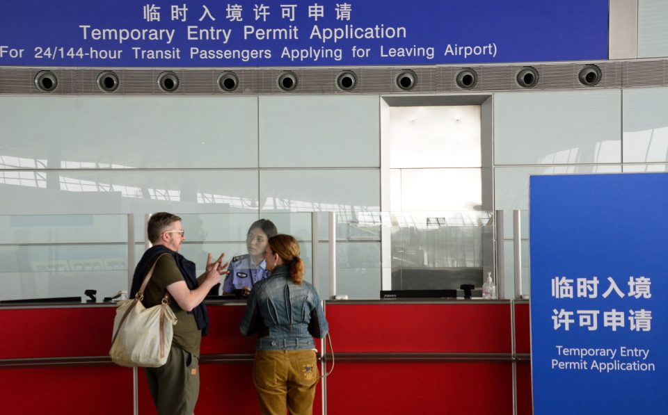 Inside Beijing Capital International Airport, a traveler checks a map
