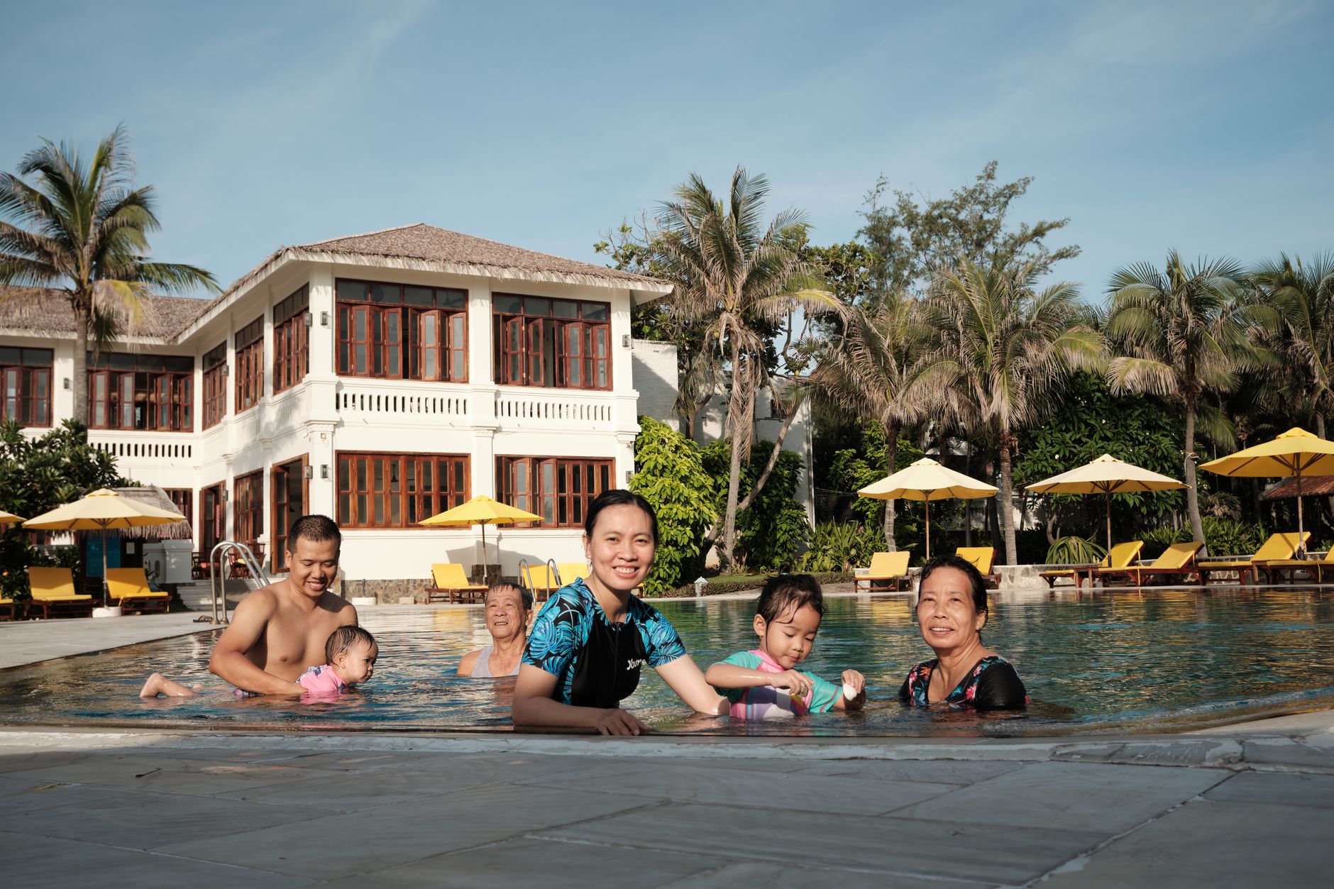 Family with children by a resort pool