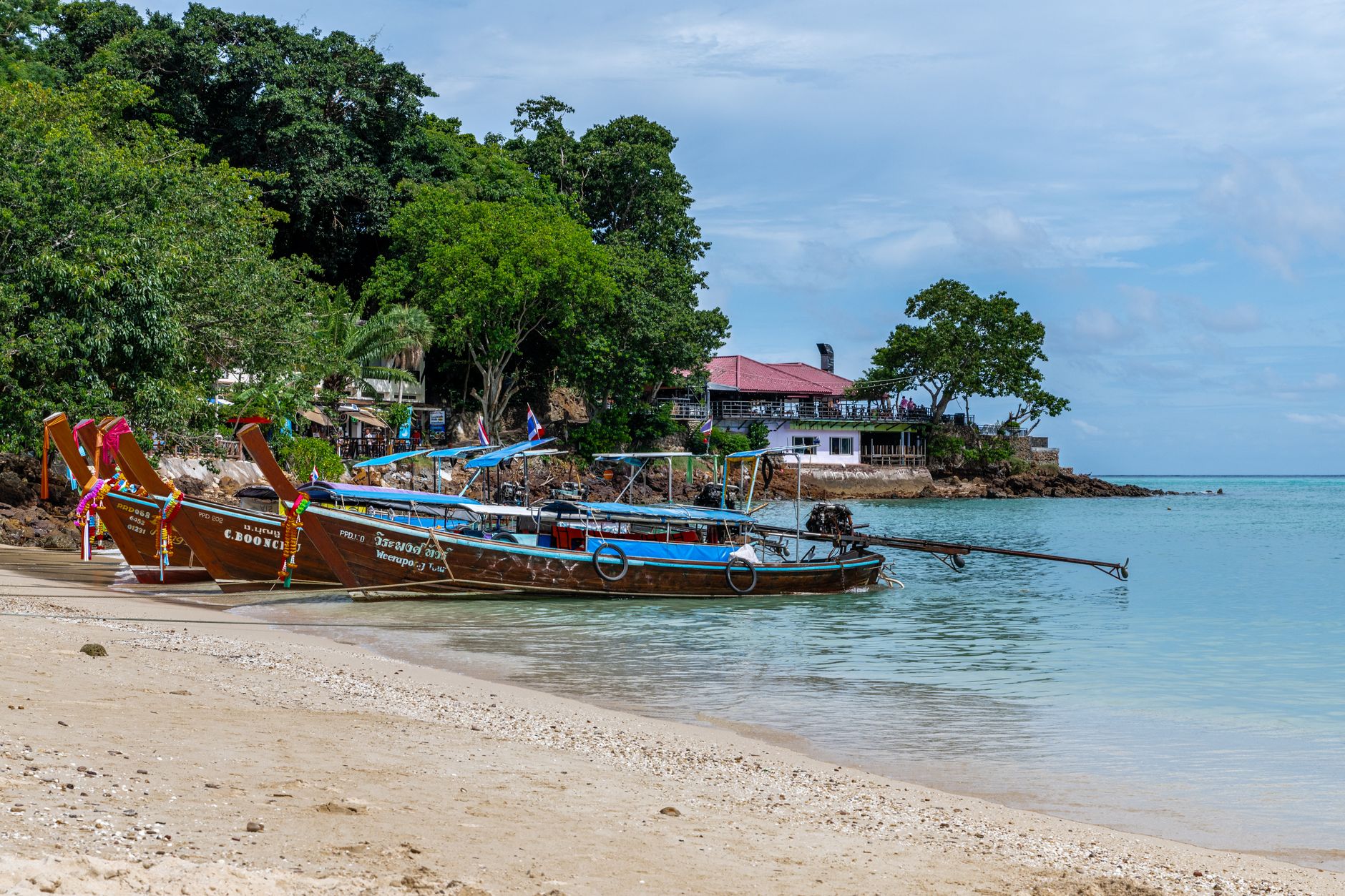 Longtail boats on a beach in Phuket, Thailand