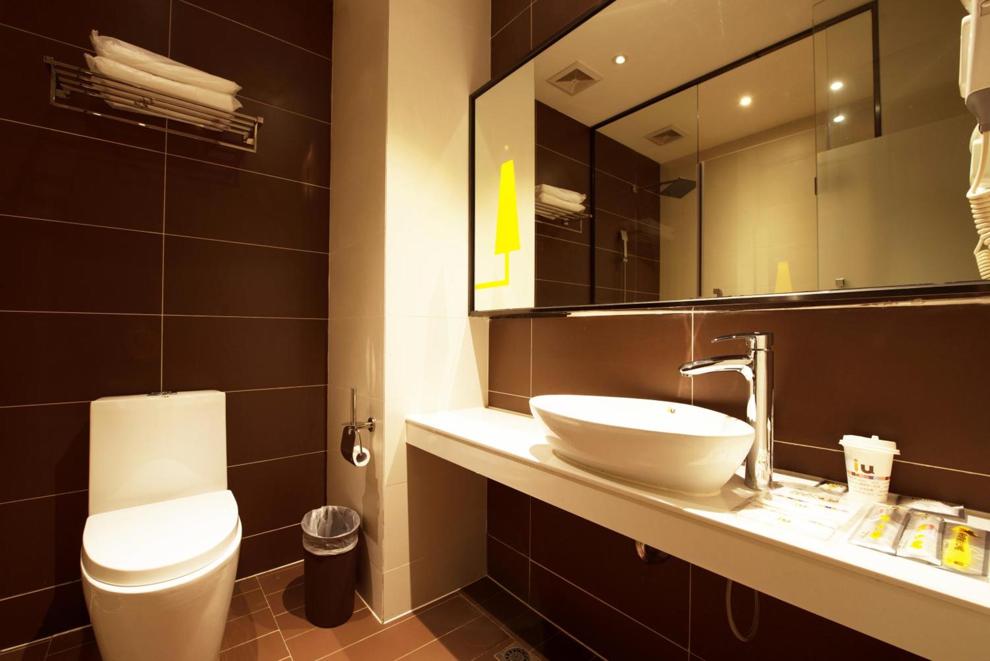 A comfortable hotel room with a large bed, modern furnishings, and a window view.