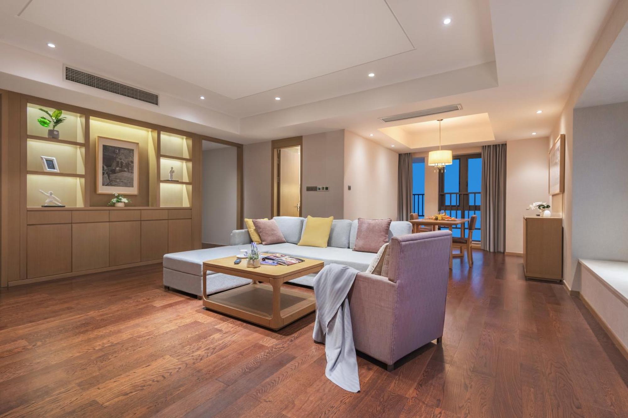 A well-appointed kitchen in an apartment, featuring a microwave and refrigerator.