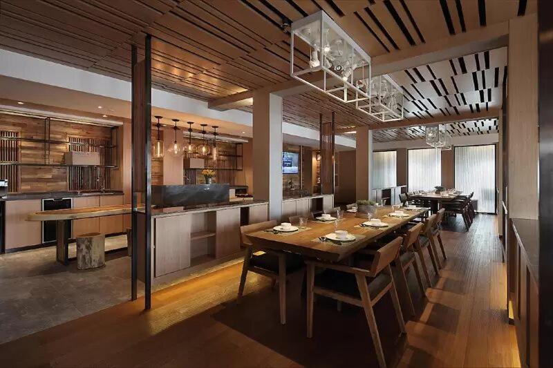 A chic hotel room with a comfortable bed, modern lighting, and elegant decor.