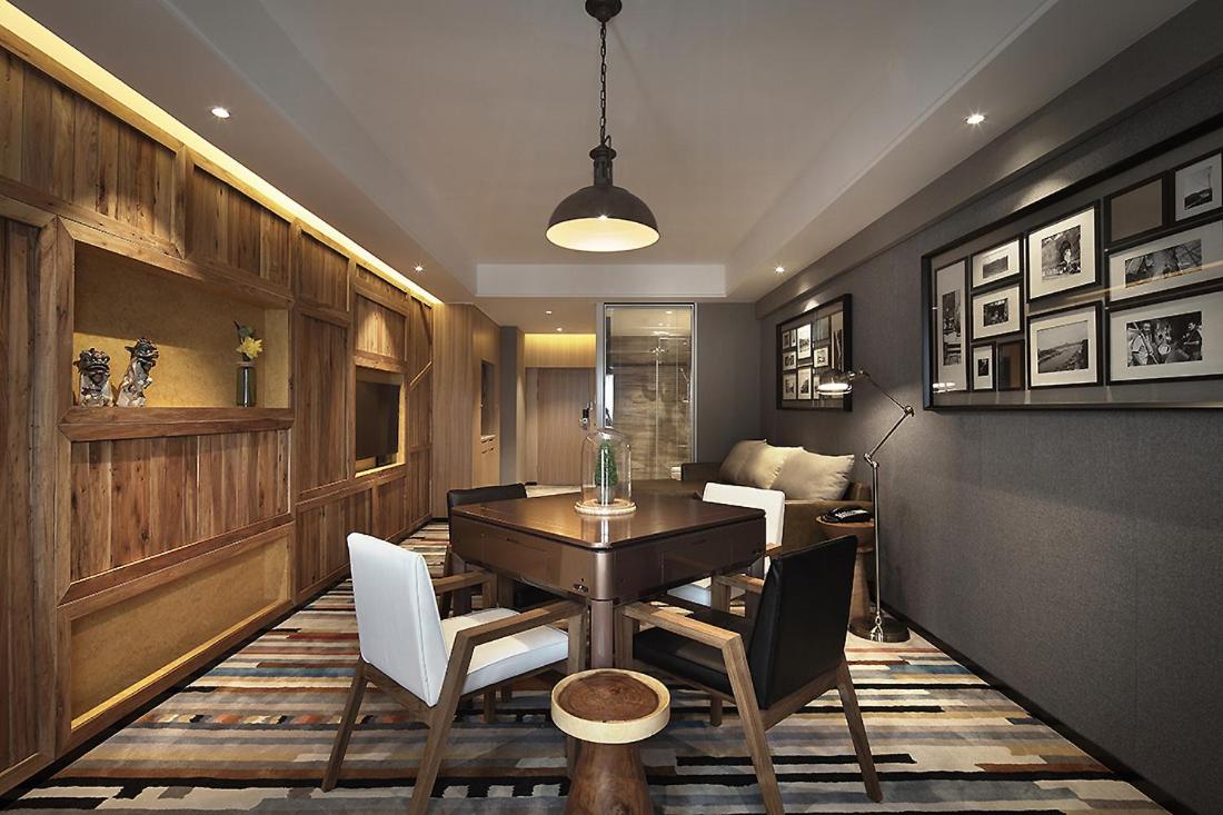 A well-appointed hotel room featuring a comfortable bed, a seating area, and tasteful decorations.